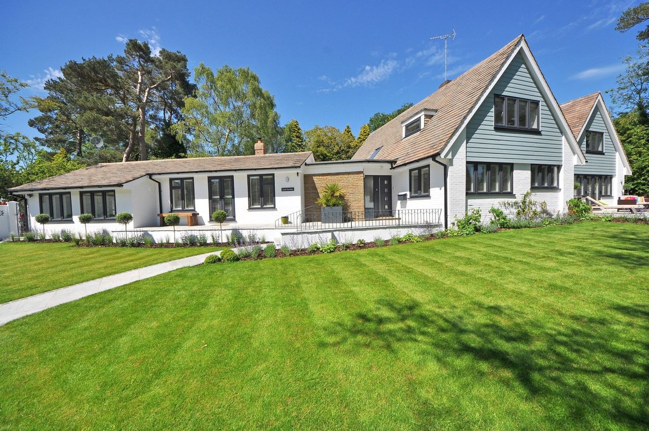 Beautifully landscaped home with a manicured lawn and clean garden beds