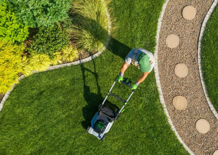 stock-photo-caucasian-gardener-mowing-backyard-garden-grass-using-cordless-electric-grass-mower-aerial-view-1794449392-1920w